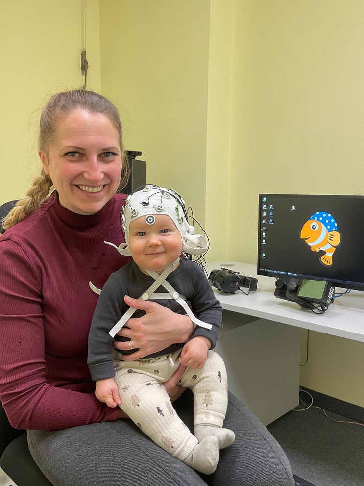 Mother with child who is wearing an EEG cap
